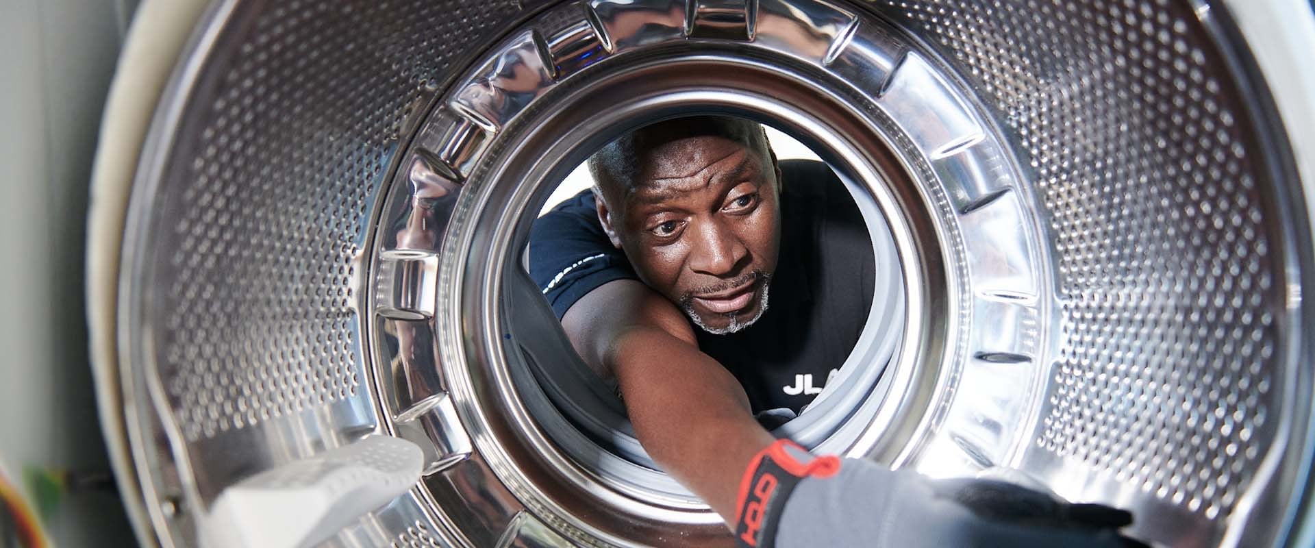 JLA engineer fixing commercial washing machine