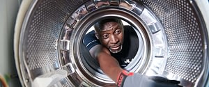 JLA engineer fixing commercial washing machine