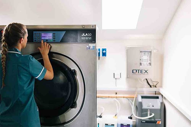 Care home worker in laundry room