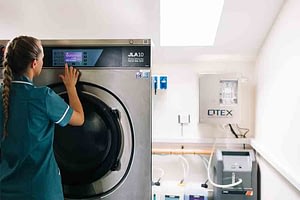 Care home worker in laundry room
